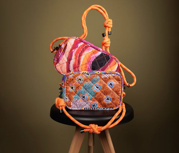 Cross Body Bag with Rope strap on a white background. Bag features Aboriginal artwork by Ruth Stewart from Warlukurlangu Artists