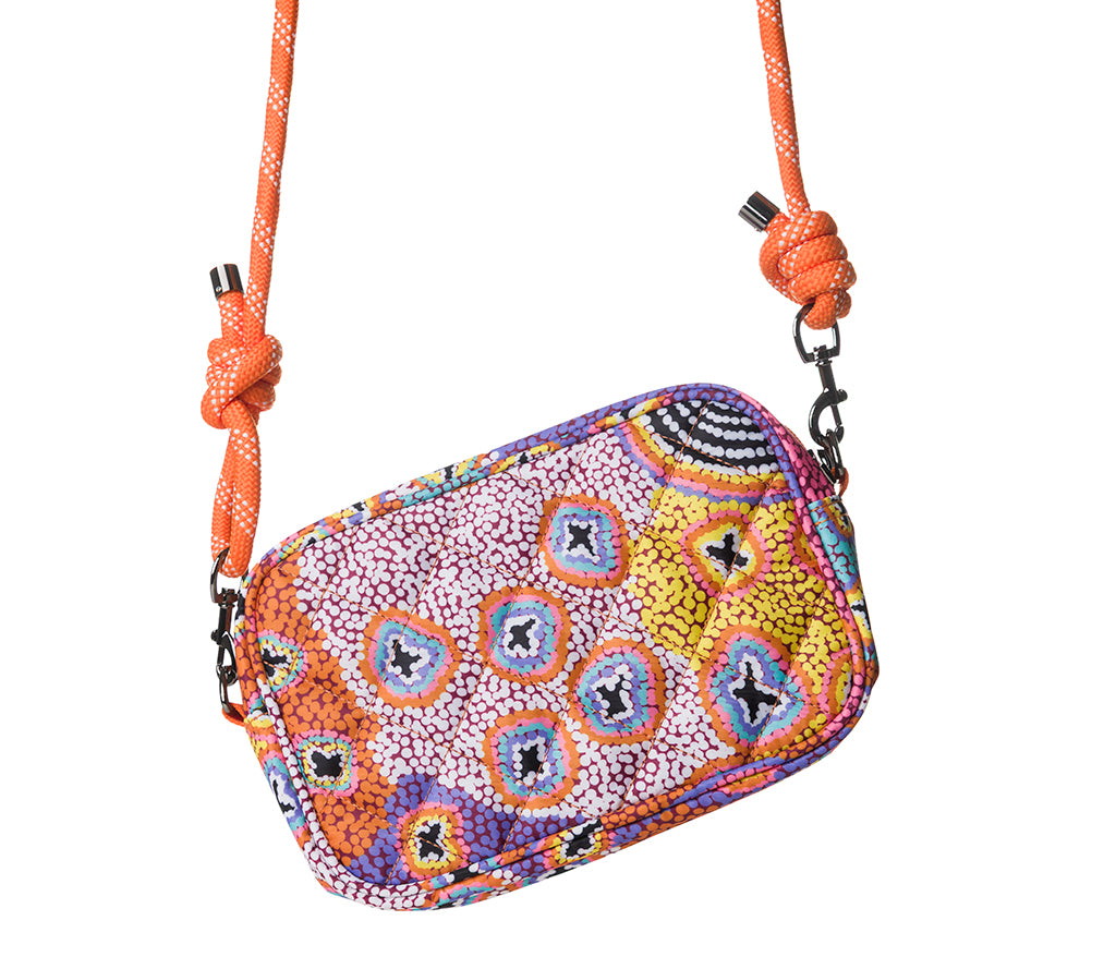 Cross Body Bag with Rope strap on a white background. Bag features Aboriginal artwork by Ruth Stewart from Warlukurlangu Artists