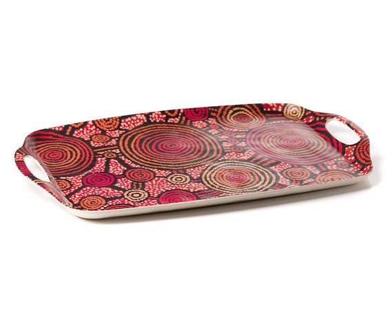 A rectangular bamboo/melamine serving tray with integrated side handles, featuring Aboriginal artwork by Teddy Gibson from Warlukurlangu Artists. Image on a white background.