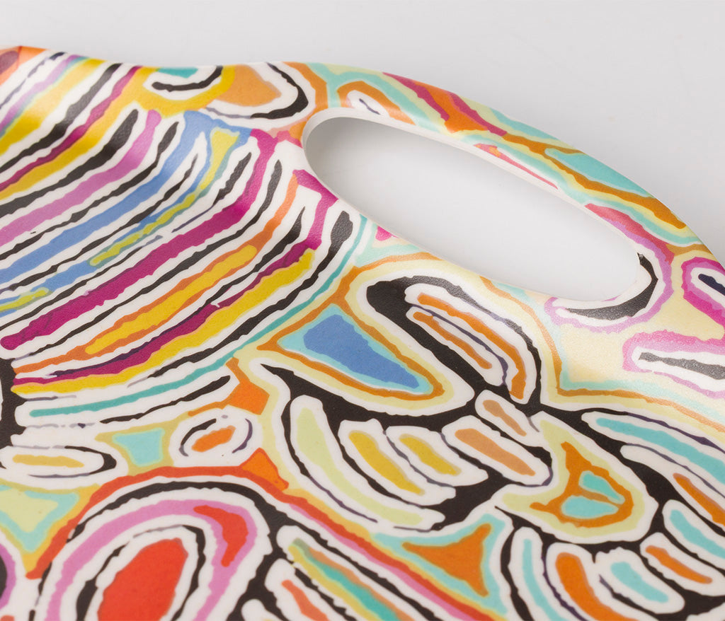 A close up of a bamboo/melamine serving tray with integrated side handles, featuring Aboriginal artwork by Judy Napangardi Watson from Warlukurlangu Artists. Image on a white background.